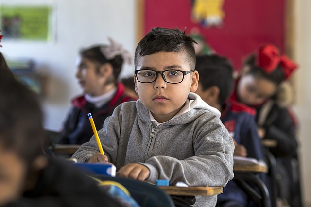 Schoolchild Listening and Taking Notes